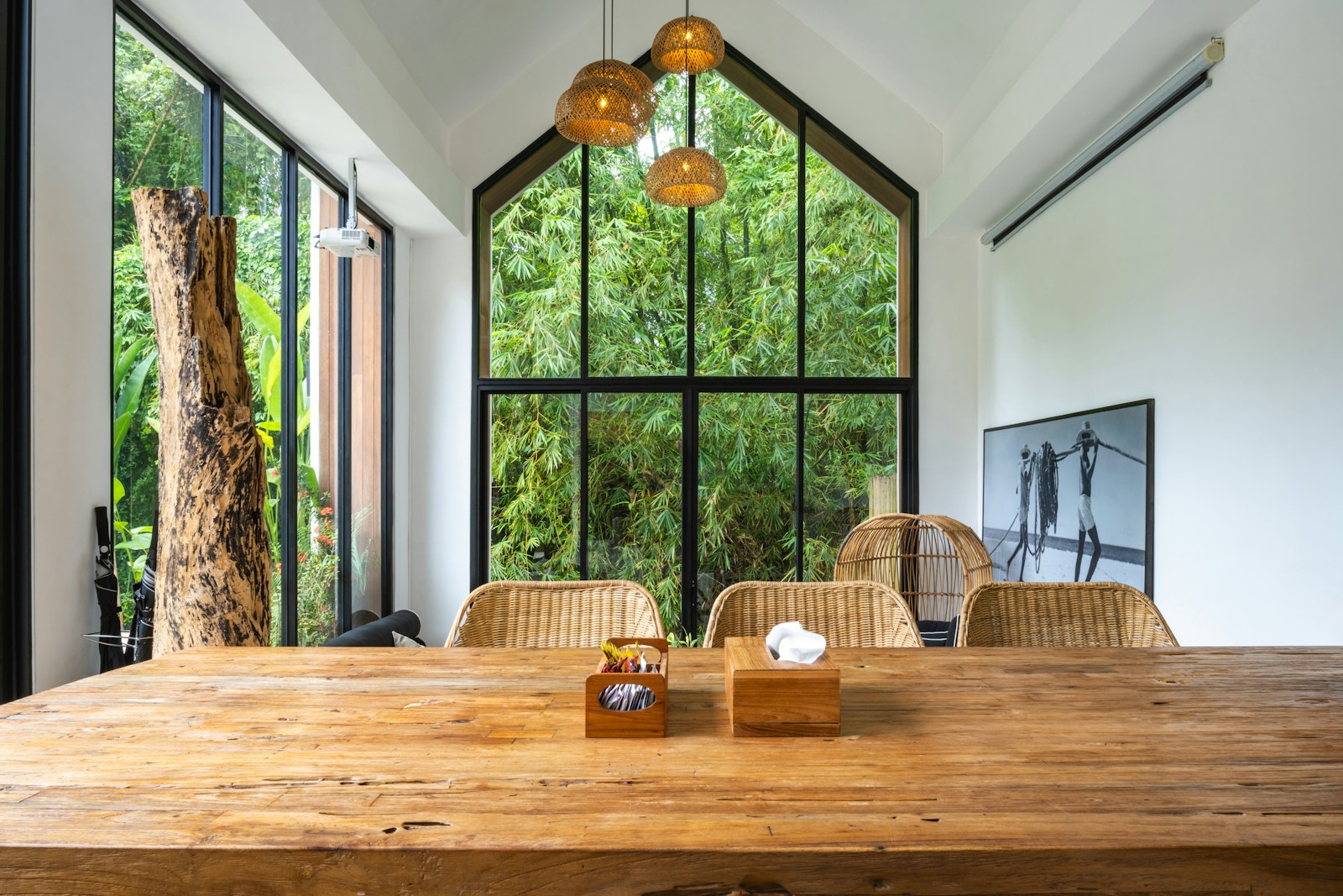 A large wooden table sitting in front of a window