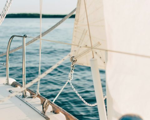 white and gray boat on body of water