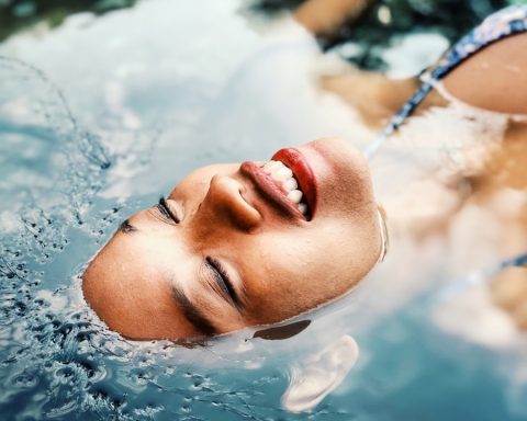 floating woman on body of water