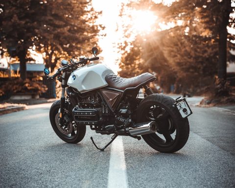 white and black BMW cruiser motorcycle in the center of road