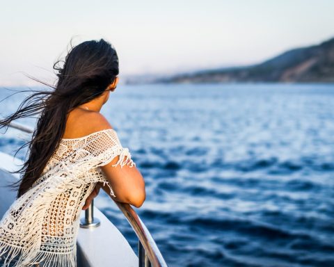 woman on the boat watching the sea