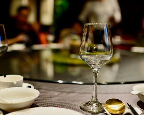 a table topped with plates and glasses of wine