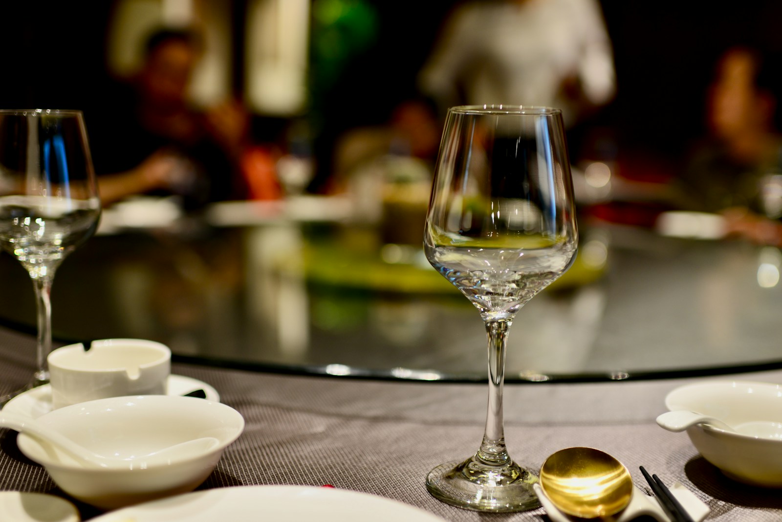 a table topped with plates and glasses of wine