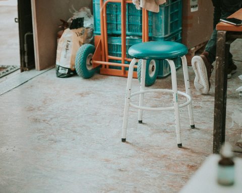 empty round green stools beside brown table