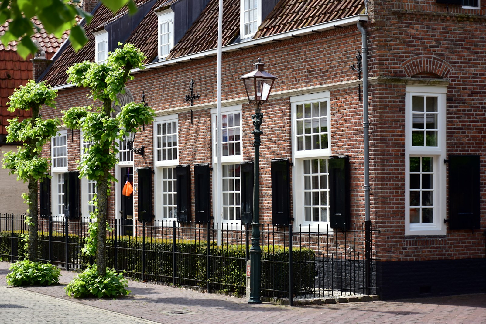 a row of brick buildings with white windows