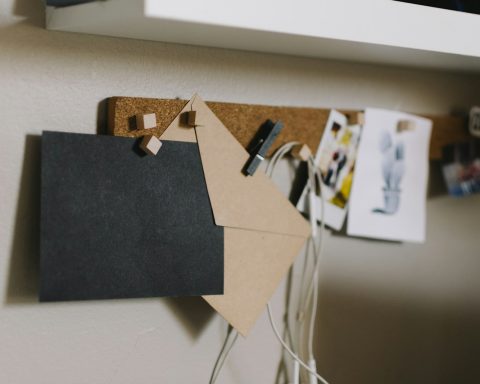 brown cork board with papers