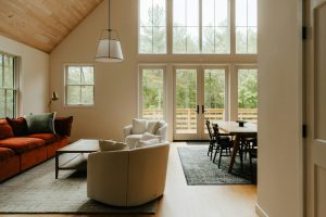 a living room filled with furniture and windows