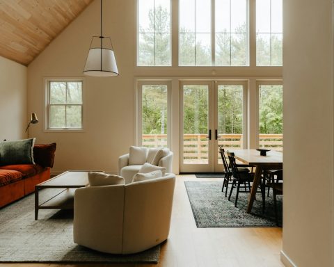 a living room filled with furniture and windows
