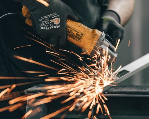 a man using a grinder on a piece of metal